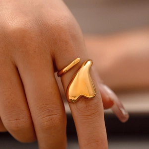 Irregular heart shaped open ring in 18k gold plated finish worn on a finger