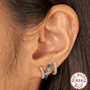 S925 sterling silver crown studs with colorful cubic zirconia worn by a model