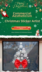 Close-up of white snowflake Christmas tree window sticker with a vivid red ribbon bow