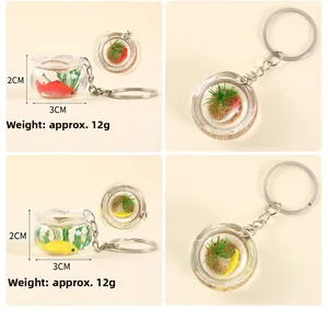 Nahaufnahme von Mini-Fischglas-Schlüsselanhängern mit künstlichen Koi-Fischen und Pflanzen