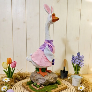 Detailed view of large porch goose in pink and purple Easter costume with rabbit ears decoration