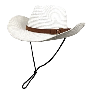 Detail of white woven straw cowboy hat featuring brown suede band and black wind rope