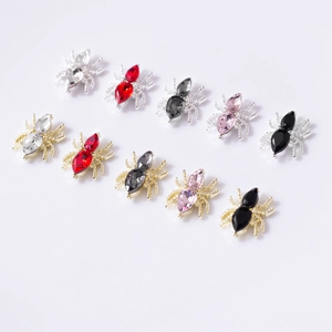 Macro detail of 3D spider nail art gems with sparkling marquise crystals in 10 color sets