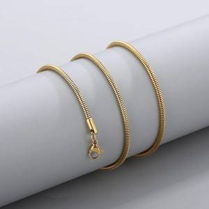 Detail of 18k gold plated snake chain necklace with lobster clasp on a grey stand