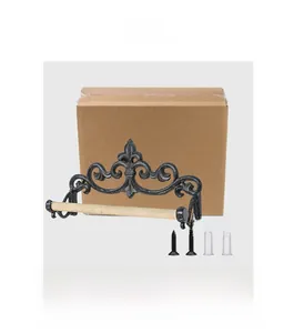 Detail of vintage cast iron paper roll holder with ornate scrolls and wooden rod