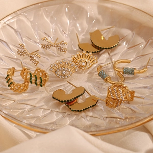 Detail view of gold 18K plated C-shape hollow earrings with micro-inlaid rhinestones
