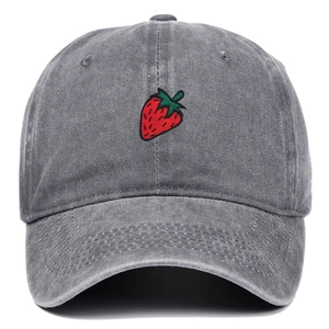 Detailed view of red strawberry embroidery on dark gray washed cotton baseball cap