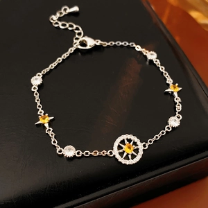 Detail of silver octagonal star compass bracelet with yellow zircon on black leather