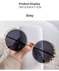 Detail of round sunglasses featuring gold metal frames and white pearl embellishments