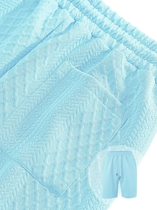 Close-up of sky blue waffle texture fabric on men's casual drawstring shorts