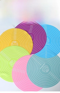Detail of colorful round silicone baking mats showing size scales and diameter marks