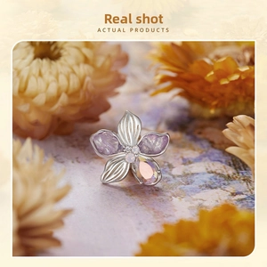 Detailed flower charm with purple texture, opal center and iridescent drop gem