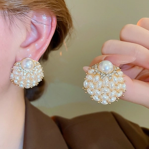 Close-up of elegant floral cluster earrings with cream pearls and sparkling crystals