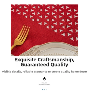 Macro detail of red laser-cut floral table runner with textured linen fabric and cutlery