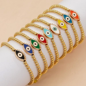 Close-up of colorful evil eye beaded bracelets with 4mm gold copper beads on a display