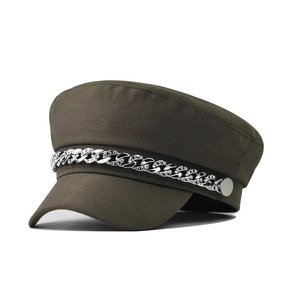 Detail of olive green newsboy cap featuring a silver rhinestone chain on the brim
