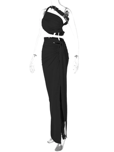 Detail of high waist side slit skirt and one-shoulder ruched top in black knitted fabric