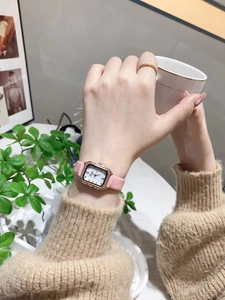 Elegant rose gold square watch with diamond bezel and pink leather strap on woman's wrist