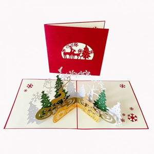 3D pop-up Christmas card featuring a red laser-cut cover and golden reindeer with trees