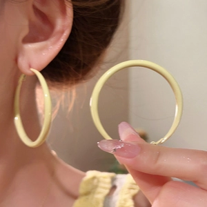 Elegant cream yellow enamel hoop earrings with a glossy finish for a minimalist summer look