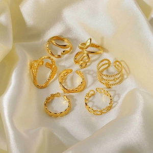 Detailed macro view of 7-piece 18K gold plated ring set on silk background