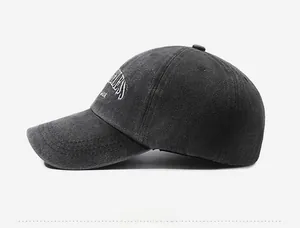 Detail of washed cotton canvas texture and 3D embroidery on dark grey baseball cap