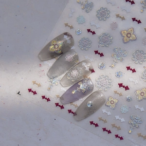 Detail of 3D embossed floral nail stickers with holographic shell luster and vintage patterns