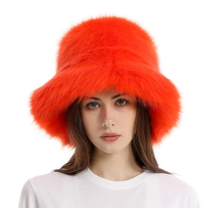 Detailed view of vibrant orange faux fox fur texture on women's winter bucket hat