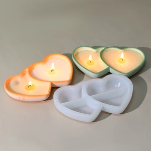 Detail showing double heart silicone candle mold with finished burning scented candles