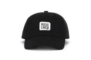 Detailed close-up of white MARIA embroidery patch on a black cotton baseball cap