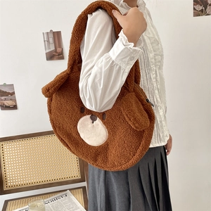Close-up of a cute brown teddy bear plush tote bag featuring curly faux shearling texture