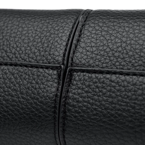Macro shot of black lychee grain leather with high-quality fine stitching detail