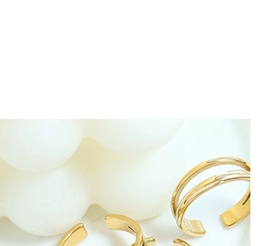 Detail of minimalist double-layered gold open ring with polished curved lines