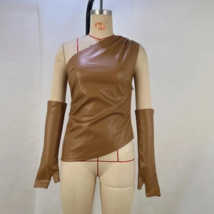 Detailed view of the brown PU leather asymmetric vest and matching arm sleeves on a mannequin