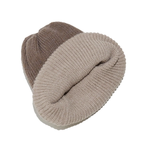 Detail of rib-knit beanie showing the dual-tone coffee and beige soft wool blend texture