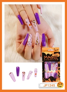 Detail of Halloween long press on nails with purple glitter, ghosts, and pumpkin packaging