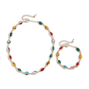 Ethnic gold chain necklace and bracelet set with colorful oval resin stones on white background