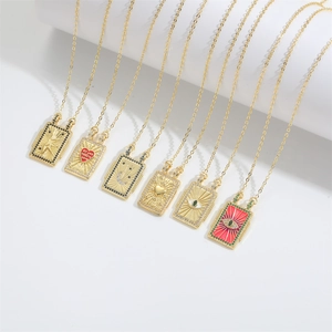 Detail view of seven vintage gold rectangle necklaces with colorful enamel and zircon charms