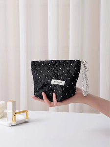 Chic black polka dot cosmetic bag with elegant pearl handle and H&R logo tag