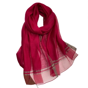 Red silk wool blend scarf with silver metallic stripes on a clean white background