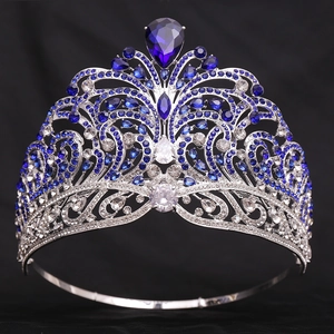 Detailed macro view of Miss World style silver crown with blue and clear rhinestones