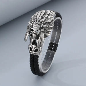 Detail of silver Indian chief skull charm on black braided leather bracelet for men
