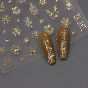 Golden Christmas nail stickers with reindeer and snowflake patterns on dark background