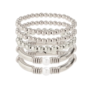 Detail of silver layered bracelet set with metallic beads and white pearl tube charms