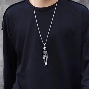 Silver skeleton pendant necklace worn on model featuring a detailed skull design