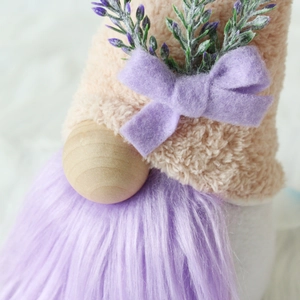 Macro detail of plush lavender gnome with a wooden nose and soft faux fur beard texture
