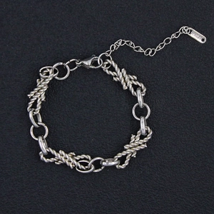 Detailed view of silver titanium steel chain bracelet with retro spiral textures