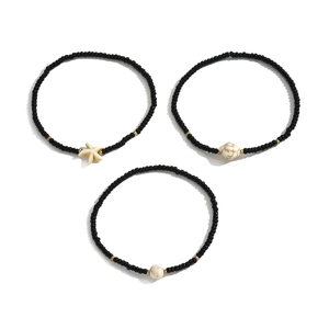 Detail of 3-piece beaded anklet set with starfish, sea turtle charms and gold accents