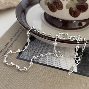 Minimalist S925 sterling silver beaded necklace with gradient size beads on vintage book