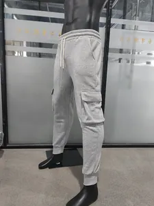 Close-up of light grey fleece cargo joggers featuring large flap pockets and drawstrings